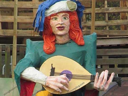 A musician plays while the castle is set to burn