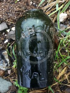 Green, clear and brown bottles are strewn all over the location to the north of the city